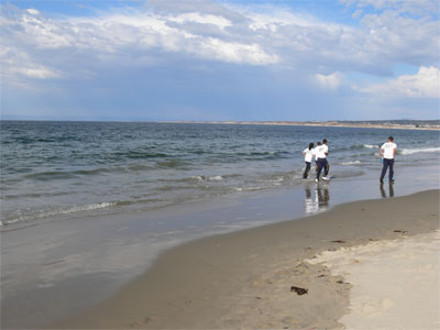 Jogging right in the water on Monterey beach 