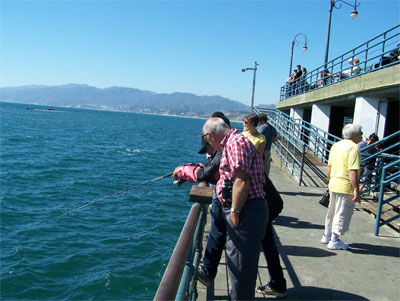 Lots of fishermen at the fishing posts at the end of the pier