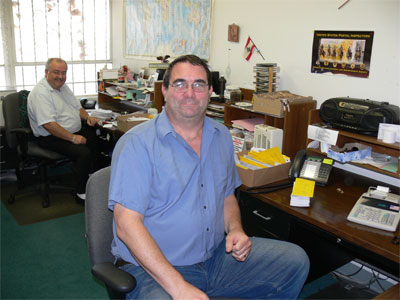 The mail room. Minas, in the back, takes care of the financial mail. The gentleman in the foreground maintains the data server and the back ups. 